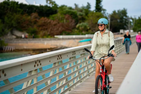 A woman in cycling along a railway trail.