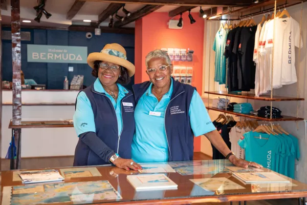 Two elderly women are smiling at the camera.