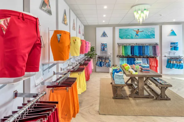 A store filled with brightly coloured Bermuda shorts. 
