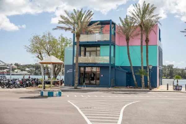 A colorful building with palm trees surrounding it.