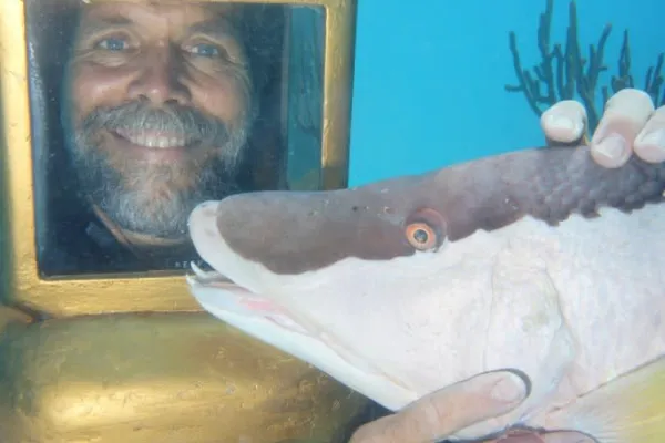 Hartley's Undersea Walk – Man Holding Fish Hartley's Helmet
