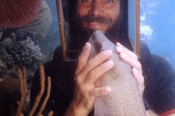 Hartley's Undersea Walk – Hartley's Helmet Diving - Man Holding Fish