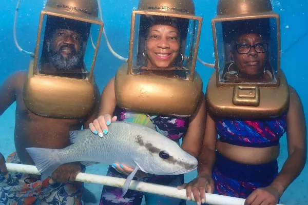 Hartley's Undersea Walk – Helmet Diver Holding Donald The Grey Snapper