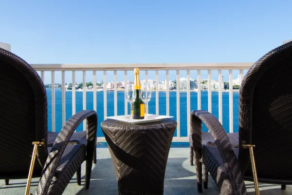 Newstead Belmont Hills Golf Resort & Spa – Champagne Site On A Table Between Two Chairs Overlooking Bermuda's Great Sound
