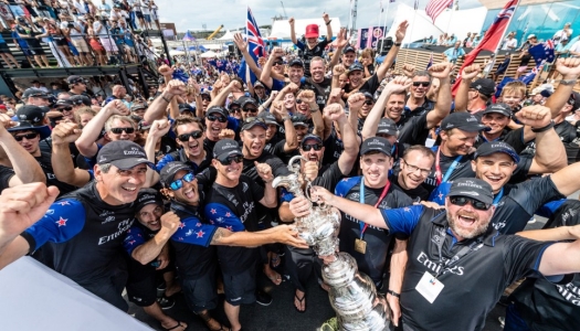 crowd of racers celebrating with a trophy