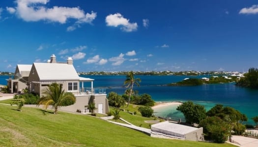 A building on a hill overlooking the water