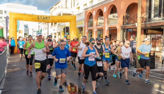 Multiple marathon runners past the start line