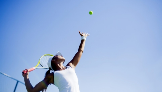 tennis player serving ball
