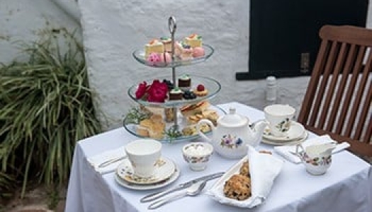 High-tea set on the table in the garden at Bermuda Perfumery