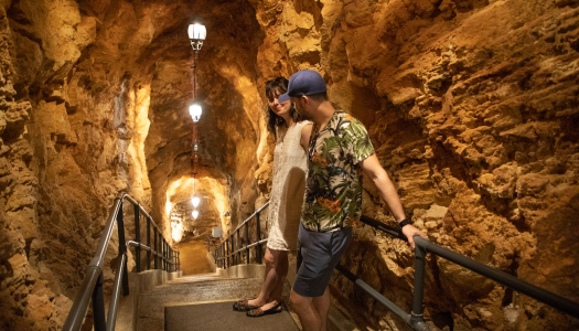 A couple walking through Crystal Caves in Bermuda