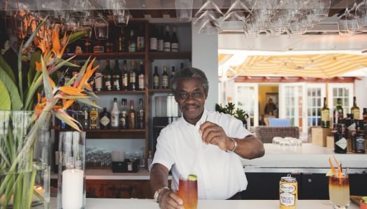 A bartender stirring a Dark n Stormy behind the bar in Bermuda