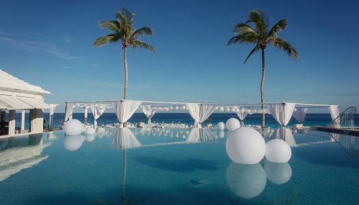 Balloons resting on an infinity pool