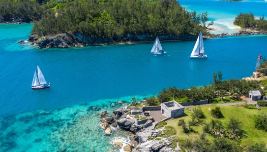 sail boats passing through a channel of water off of the coast of Bermuda
