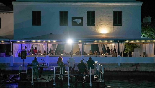 A band are performing on a floating dock.