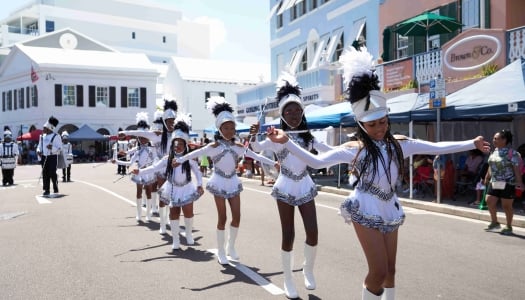 A group of young girls are dancing in majorettes. 