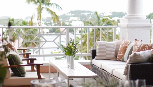 Two couches with a water view in the back.