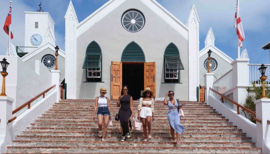 A group of friends are walking out of a church.