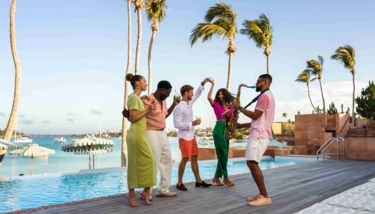 A group of friends are dancing with a saxophone player.