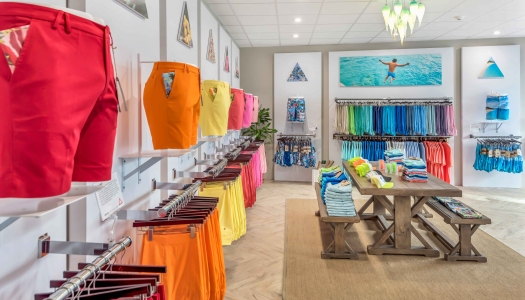 A store filled with brightly coloured Bermuda shorts. 