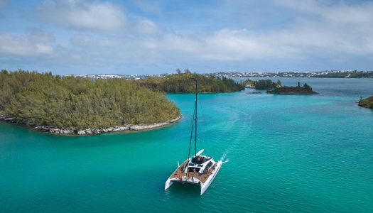 An aerial view of the great sound with a large catamaran in the middle.