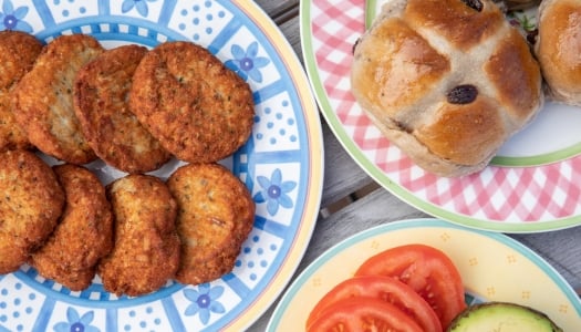 Plates filled with fishcakes and hot cross buns.