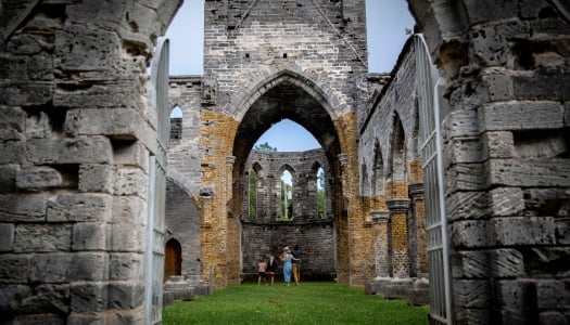 A family is standing in an unfinished church.