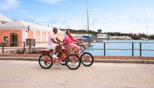 A couple is riding bicycles down St. George's.