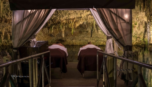 A couple is having a massage in a cave. 