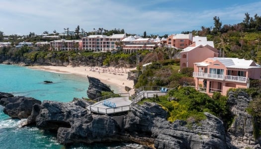 Birds eye view of The Reefs with deck and beach.