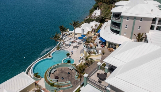 Aerial view of Newstead Belmont hotel with a lush greenery and a pool.