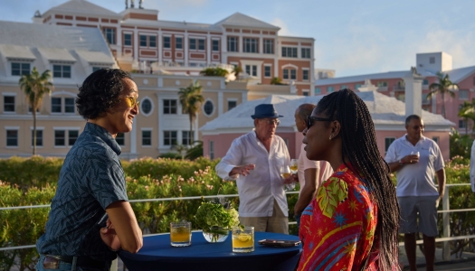 Two people are talking to each other with a scenic background.