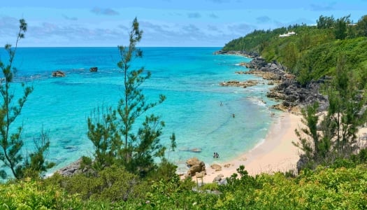 Aerial view of people swimming at the quiet Church Bay.