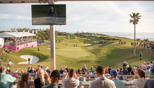 People watching the Butterfield Golf Championship on a calm day.