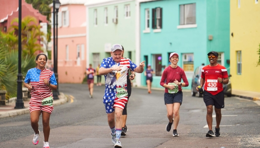 A group of people are running smiling at Flatts Village.