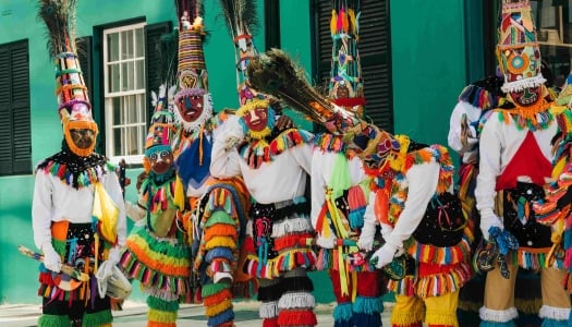 A group of colourful Bermuda gombeys are posing for the camera.