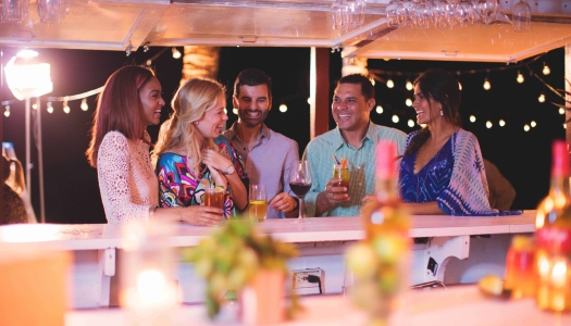 A group of friends are celebrating by the bar.