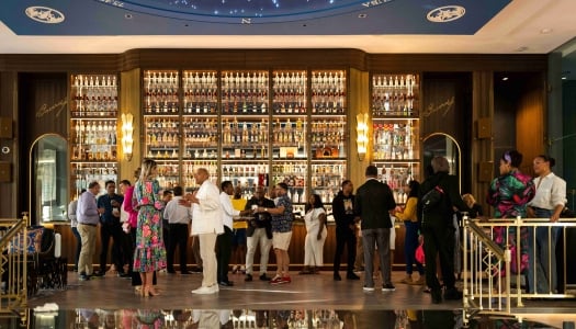 A group of people are standing in the Bacardi Headquarters building.