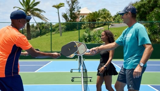 A group is playing pickleball.