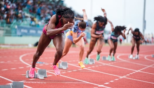 A group of women are running on a track.