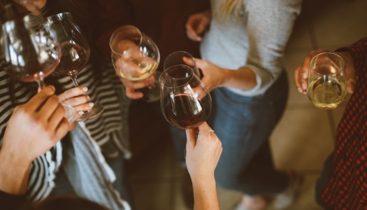 A group of friends are wine tasting.