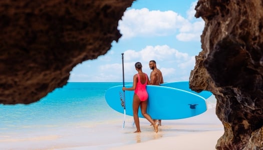 Two people are paddleboarding.