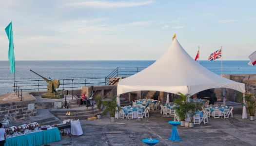 View of Fort St. Catherine set up for an event with ocean views in the background.