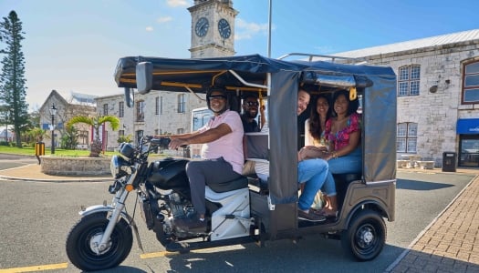 People are sitting in the Tuk Tuk tour.