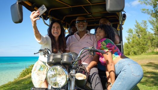 A group are sitting in a tuk tuk tour.