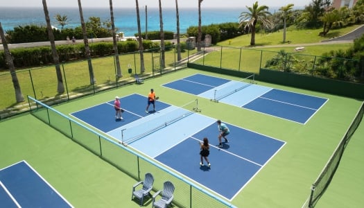 An aerial view of a group of people are playing pickleball.
