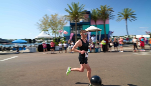 A man is running on front street by the VSC on Bermuda Day