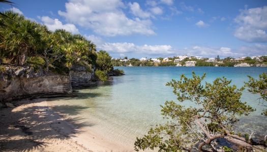 Crystal clear waters with colourful houses in the background.