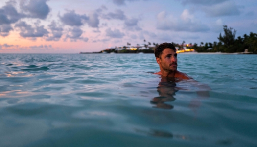 A man is swimming at the beach.