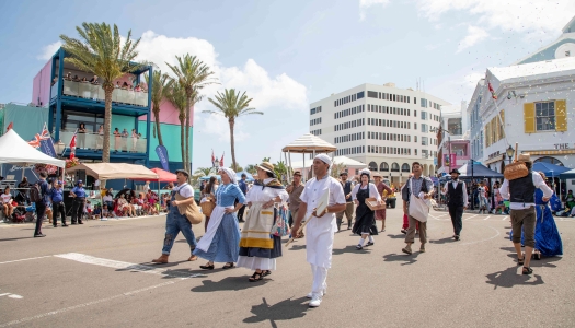A group of people are walking in the Bermuda Day parade.