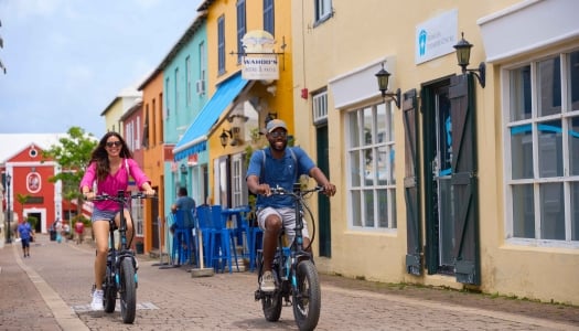 Two people riding bicycles in St. George's